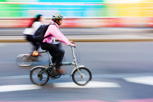 cyclist in motion blur in the city traffic of London, UK