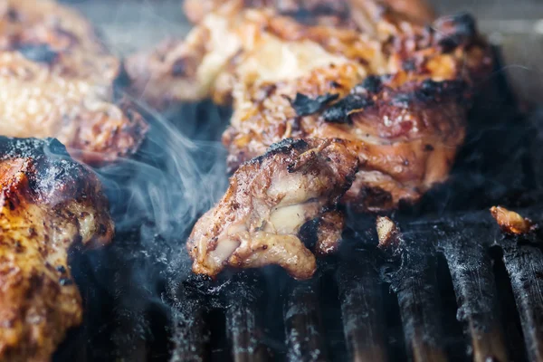 Smoking meat on a grill — Stock Photo, Image