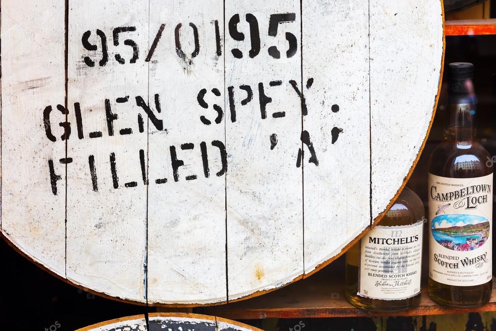 Whisky barrel and bottles in a window display Stock Editorial Photo