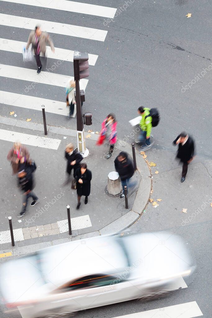 aerial view of people in motion blur crossing a street in the city