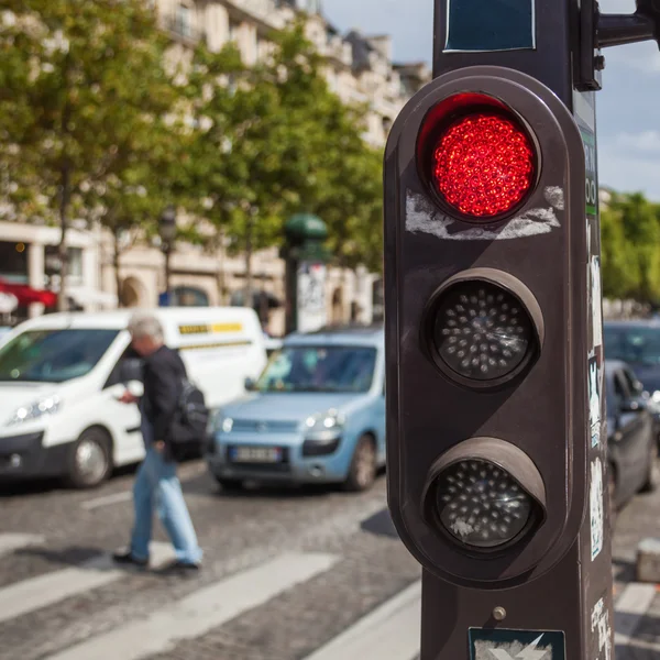Semáforo vermelho com o tráfego no fundo embaçado — Fotografia de Stock