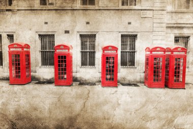 Picture of red phone boxés in London processed with a vintage texture