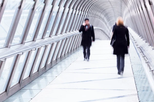 Business people walking on a footbridge — Stock Photo, Image