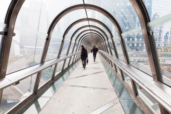 Business people walking on a footbridge — Stock Photo, Image