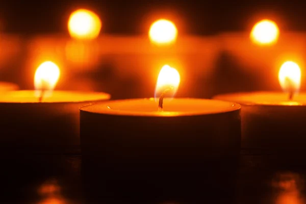 Burning tea lights in the dark — Stock Photo, Image