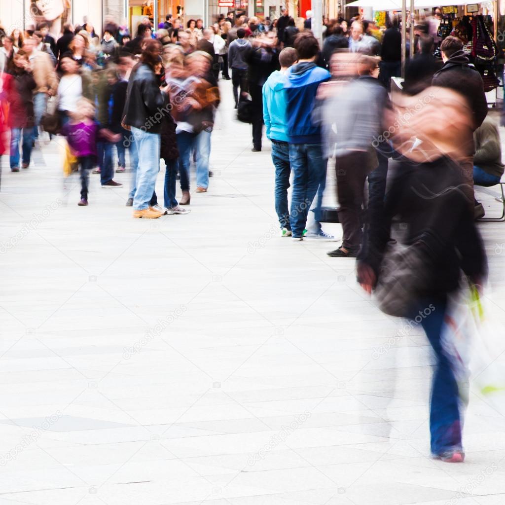 Crowd of shopping people in motion blur in the city