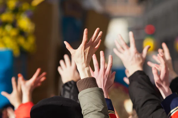 Crowd of people raising their hands — Stock Photo, Image