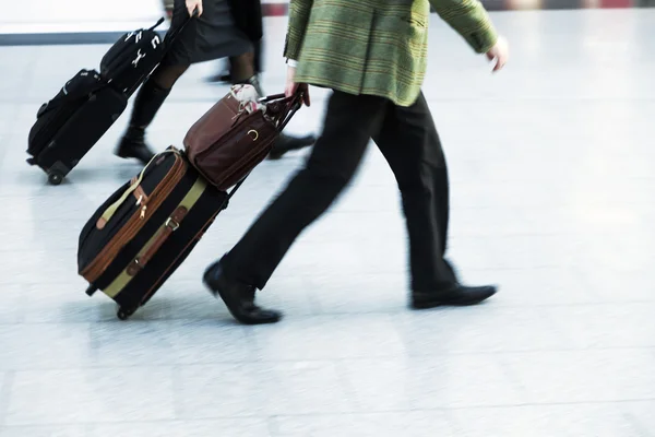 Personas urgentes con bolsas de carro en el aeropuerto —  Fotos de Stock