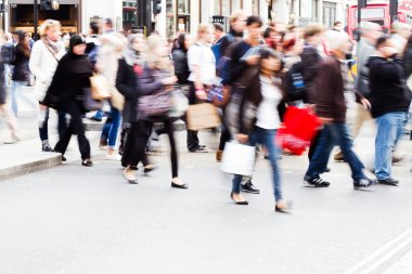 People in motion blur crossing a street in London City clipart