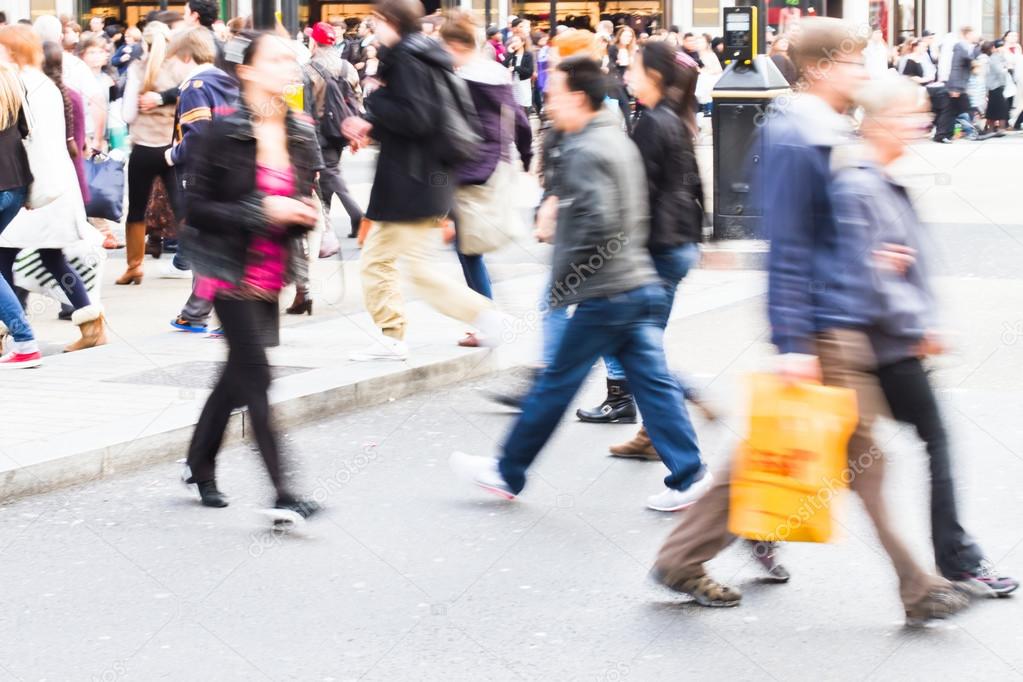 People in motion blur crossing a street in London City