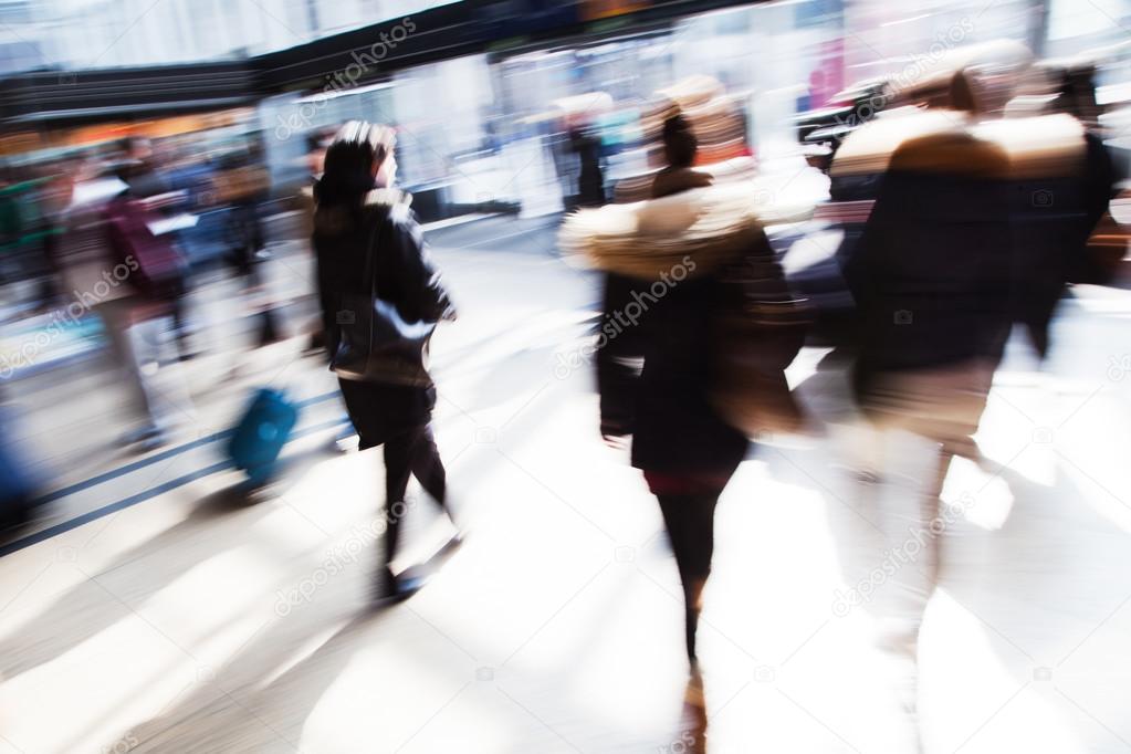 People in a railway station in motion blur