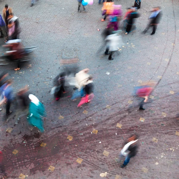 Aerial view of people in motion blur moving on a city square — Stock Photo, Image