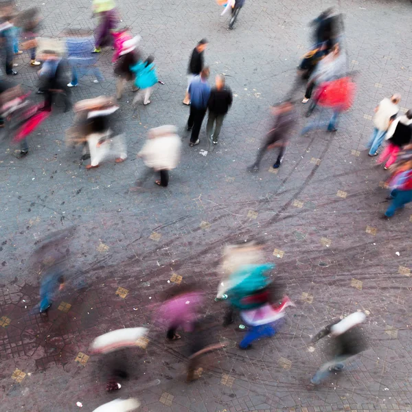 Aerial view of people in motion blur moving on a city square — Stock Photo, Image