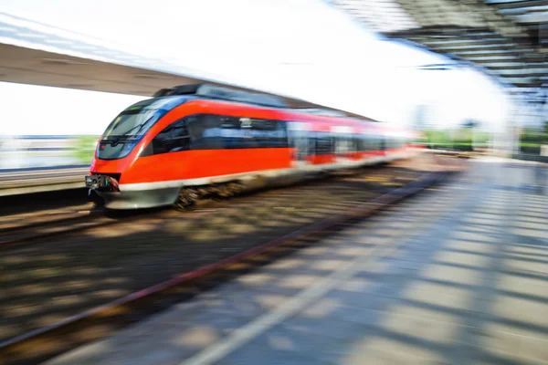 Tåget anländer till en järnvägsstation i rörelseoskärpa — Stockfoto