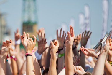 Raised hands of a crowd of people at a sport event