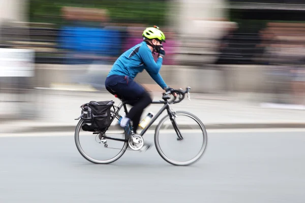 Bicycle rider in motion blur — Stock Photo, Image