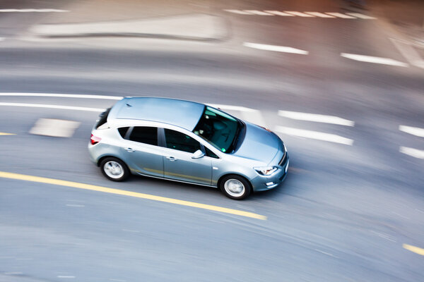 Aerial view of a driving car in motion blur