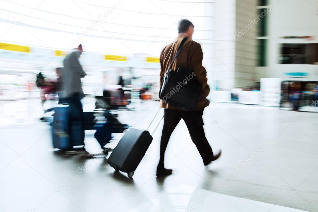 Traveling people at an airport in motion blur