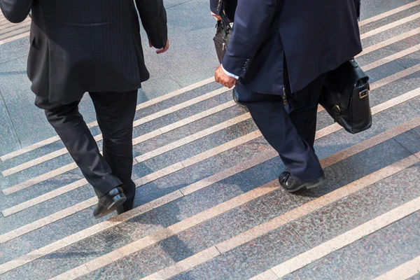 Businessmen walking downstairs — Stock Photo, Image