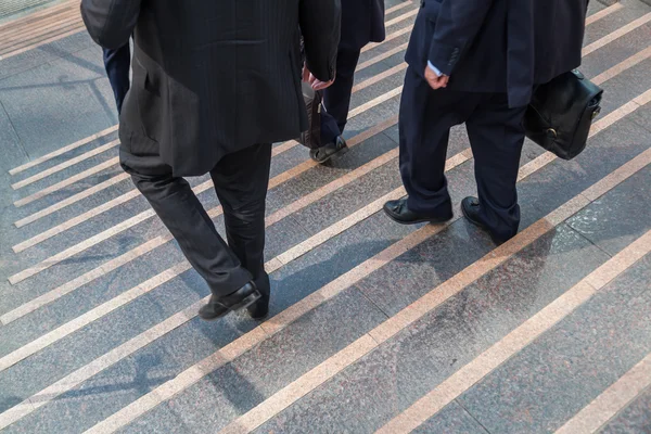 Businessmen walking downstairs — Stock Photo, Image