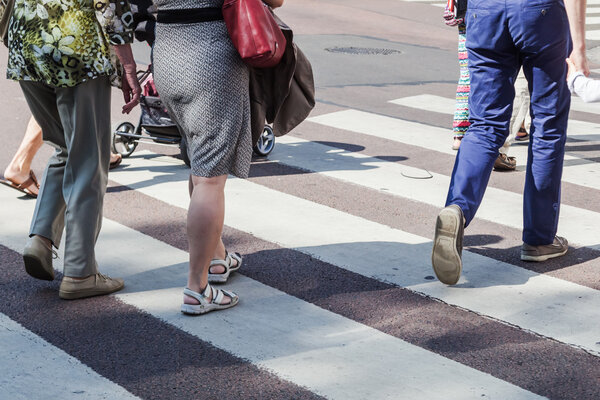 People crossing a road at the pedestrian crossing