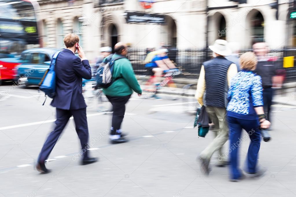 People in motion blur crossing a street in London City