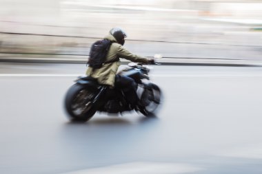 Motorcycle rider in motion blur clipart