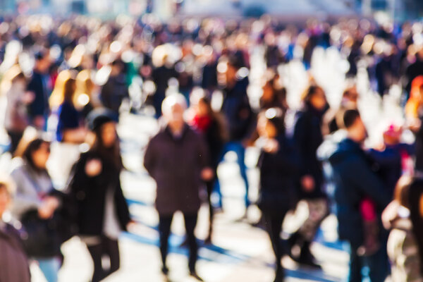 Crowd of people in the city out of focus