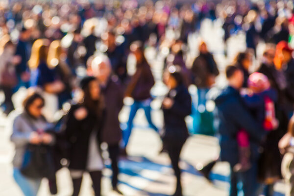 Crowd of people in the city out of focus