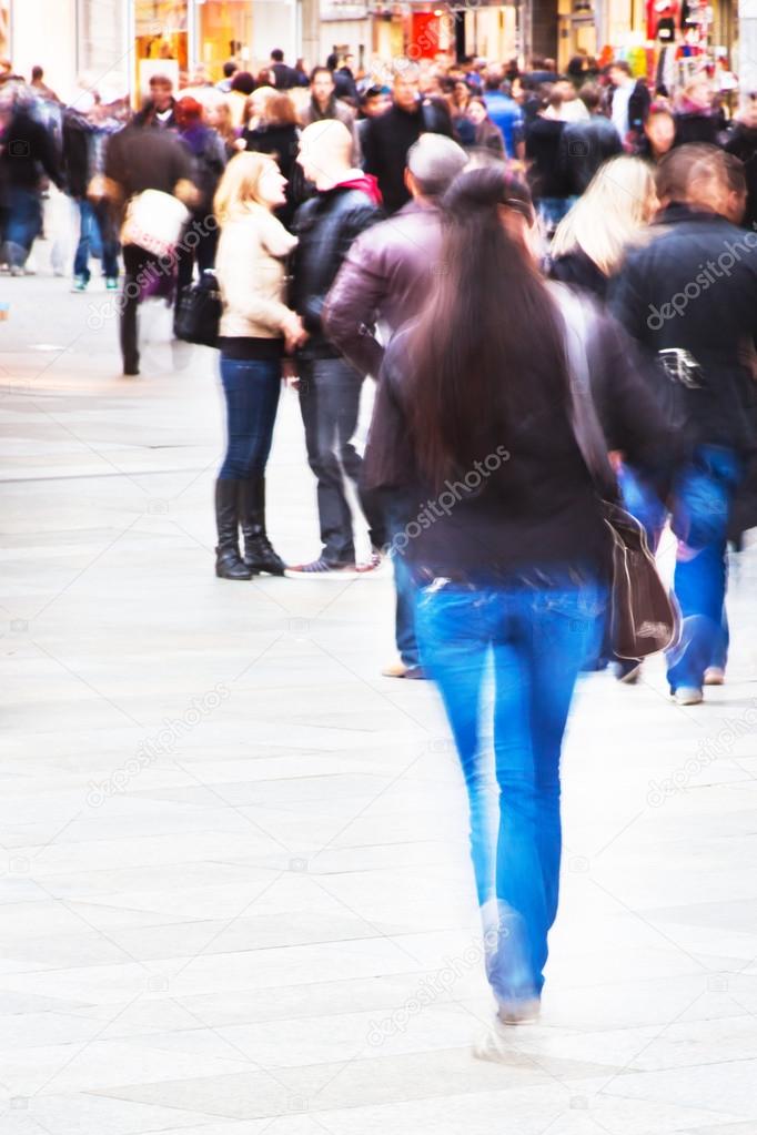 Crowd of people in motion blur on the move in the city