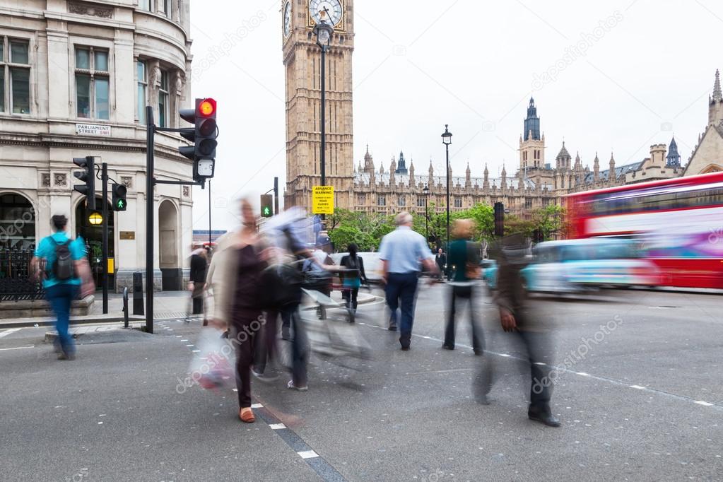 People in motion blur crossing a street in London