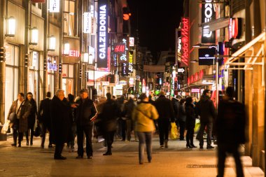 Crowd of people in the shopping street Hohe Straße in Cologne, Germany, at night
