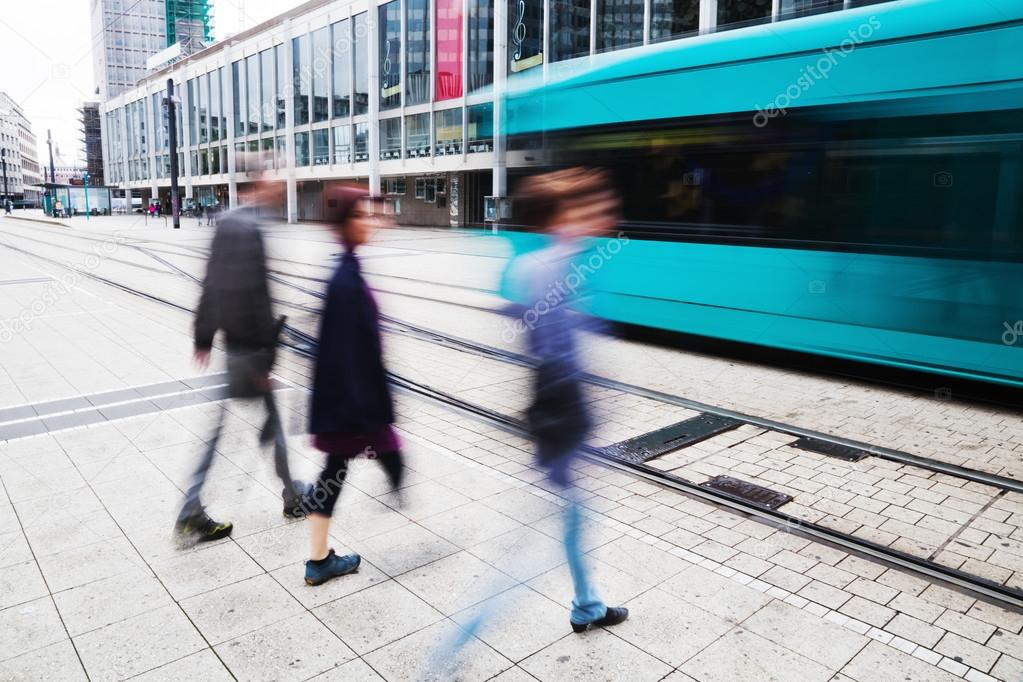 Street view of the financial district in Frankfurt, Germany, with tram and people in motion blur