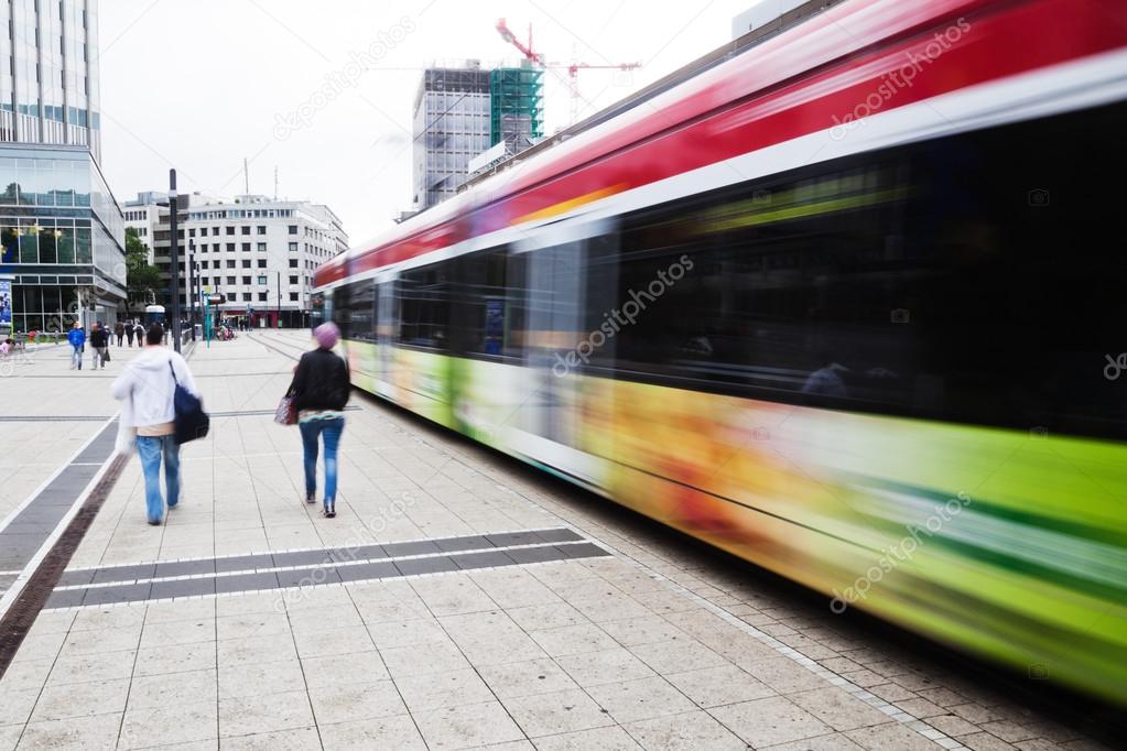 Street view of the financial district in Frankfurt, Germany, with tram and people in motion blur