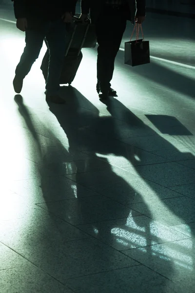 Viajar personas en un aeropuerto con retroiluminación —  Fotos de Stock