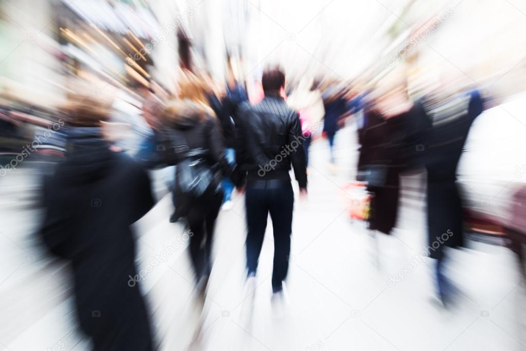 Crowd of people walking in ghte city with creative zoom effect