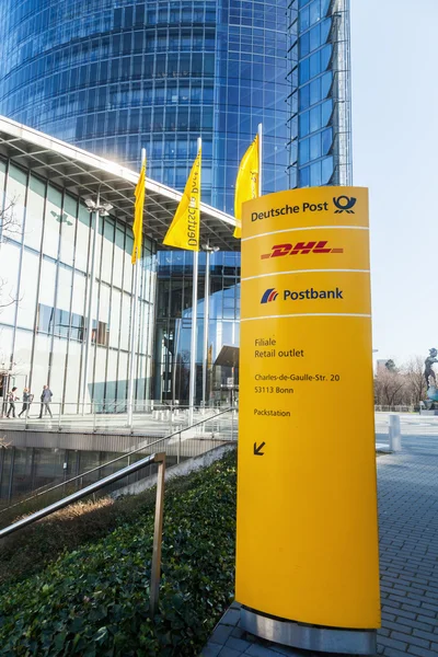 Signpost in front of the Deutsche Post Tower in Bonn, Germany