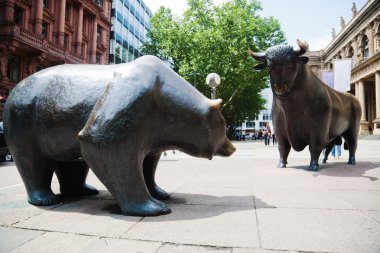 Statues of the two symbolic beasts of finance, the bear and the bull, in front of the Frankfurt Stock Exchange clipart