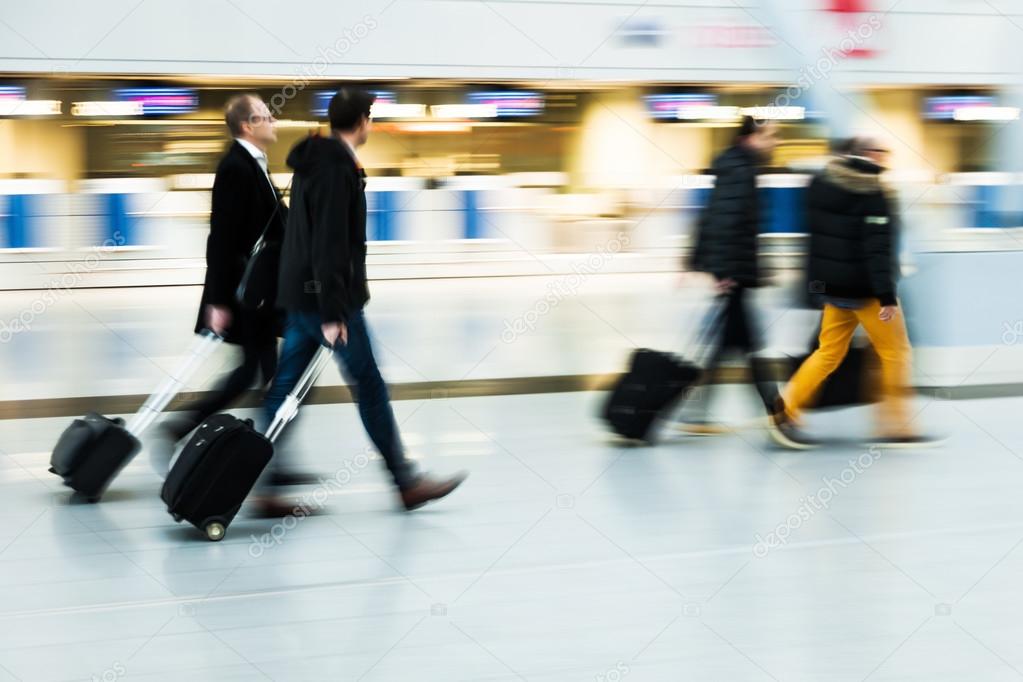 Traveling buisiness people at the airport in motion blur