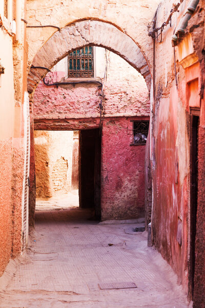 Typical red colored alley in the UNESCO protected medina of Marrakech, Morocco