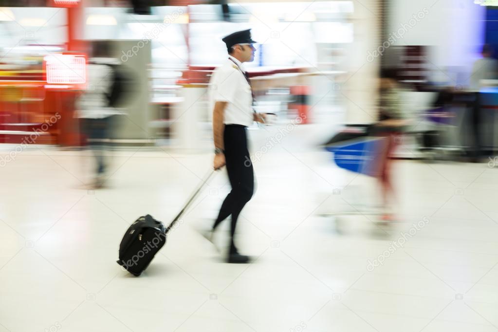 People on the move at the airport in motion blur