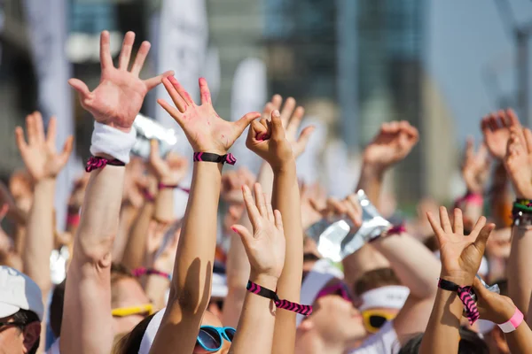 Crowd of people raising their hands and have fun