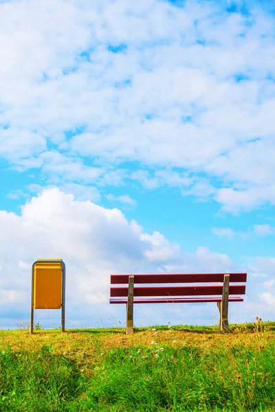 Bench and dustbin on an embankment — Stock Photo, Image