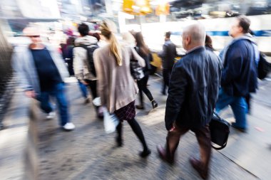 creative blur picture of commuters walking on the street