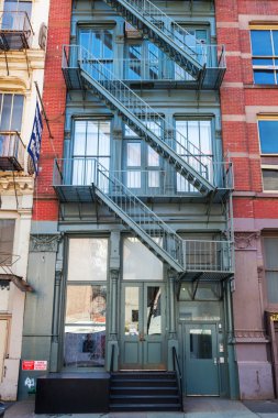 old buildings with fire escape stairs in Soho, NYC clipart
