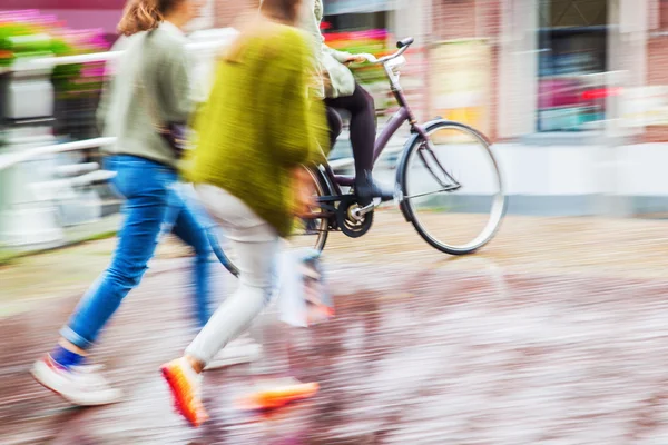 People walking in the rainy city in motion blur — Stock Photo, Image