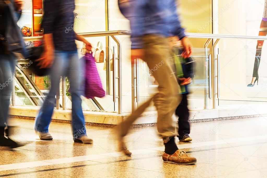 people in motion blur in a mall