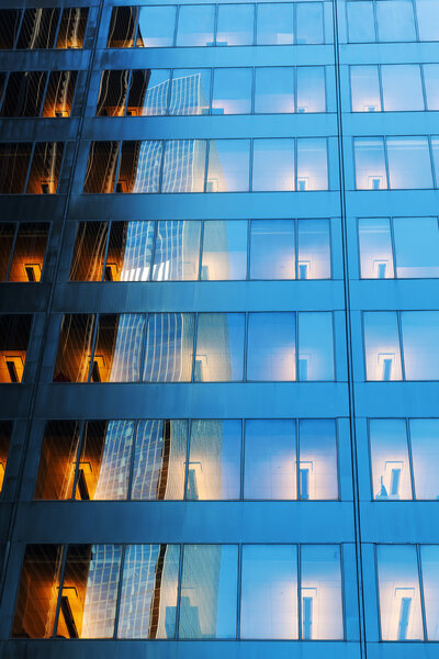 Facade of an office building with lightened offices