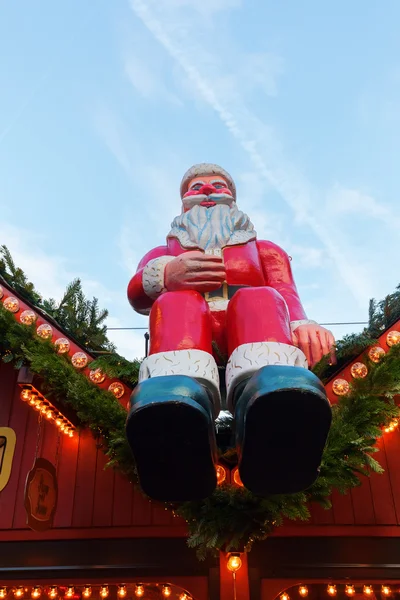 Santa Claus sitting on a stall of a Christmas Market — Stock Photo, Image