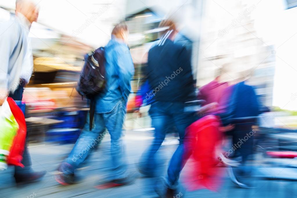 crowd of people in motion blur walking in the city
